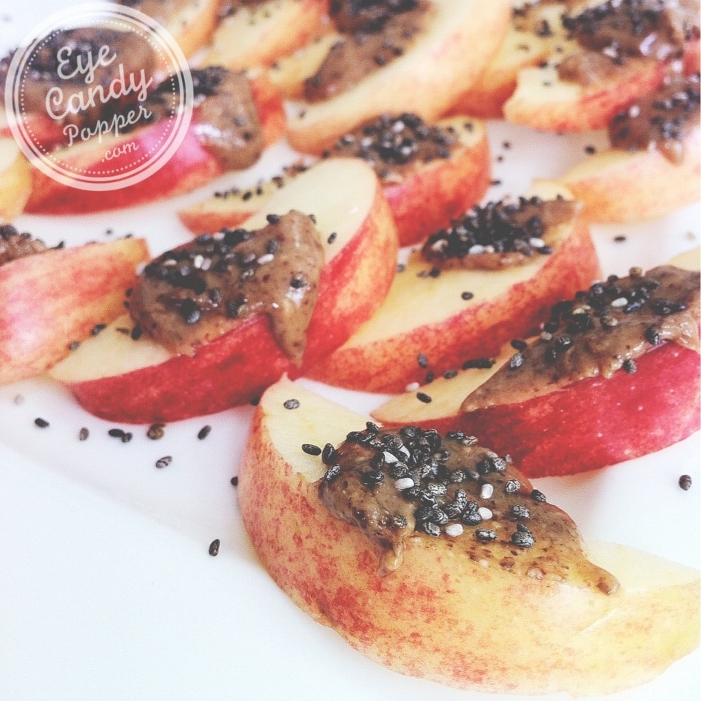 apple slices with almond butter and chia seeds on top