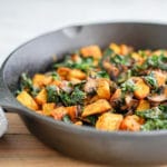 45 degree angle view of Potato, Mushroom and Kale Hash in a cast-iron skillet