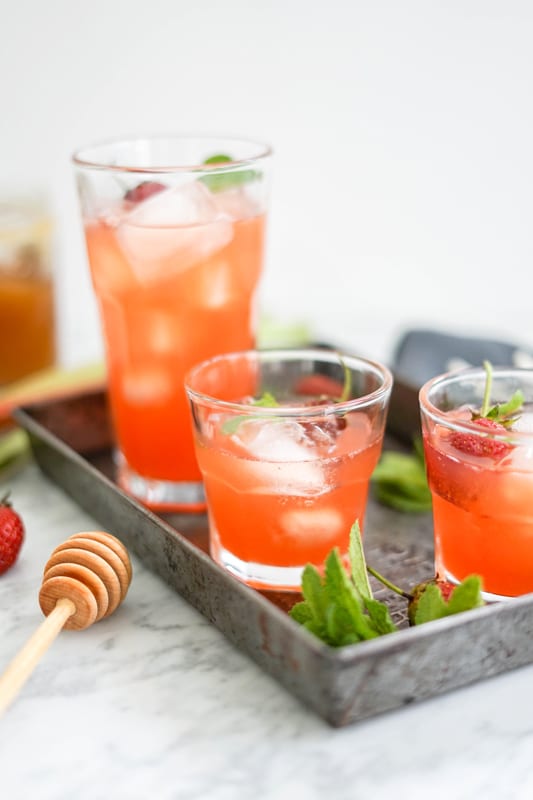 3 glasses of strawberry rhubarb lemonade in an old metal tray