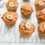 horizontal view of several muffins on a cooling rack