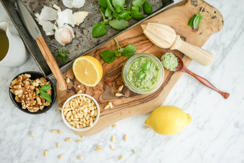 aerial view of pesto ingredients on a white marble table