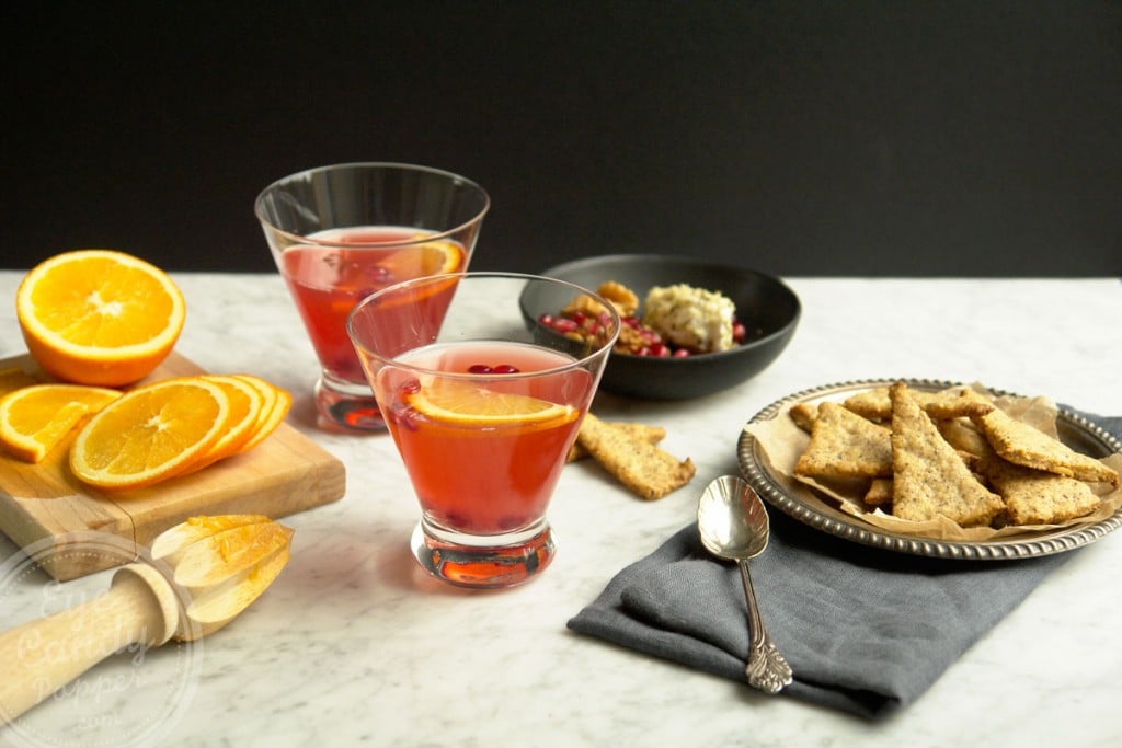 Amaretto cranberry shrub cocktail and herbs black pepper crackers